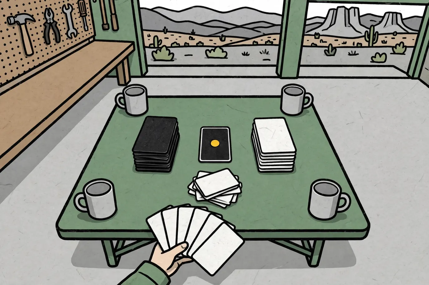 Stacks of plain black and white cards on a folding table, with a hand holding a fan of face-down cards